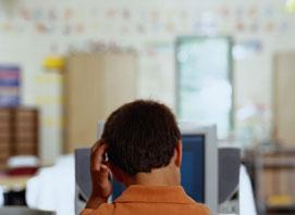 A man seen from behind sitting at a desk scratching his headAnxiety Management